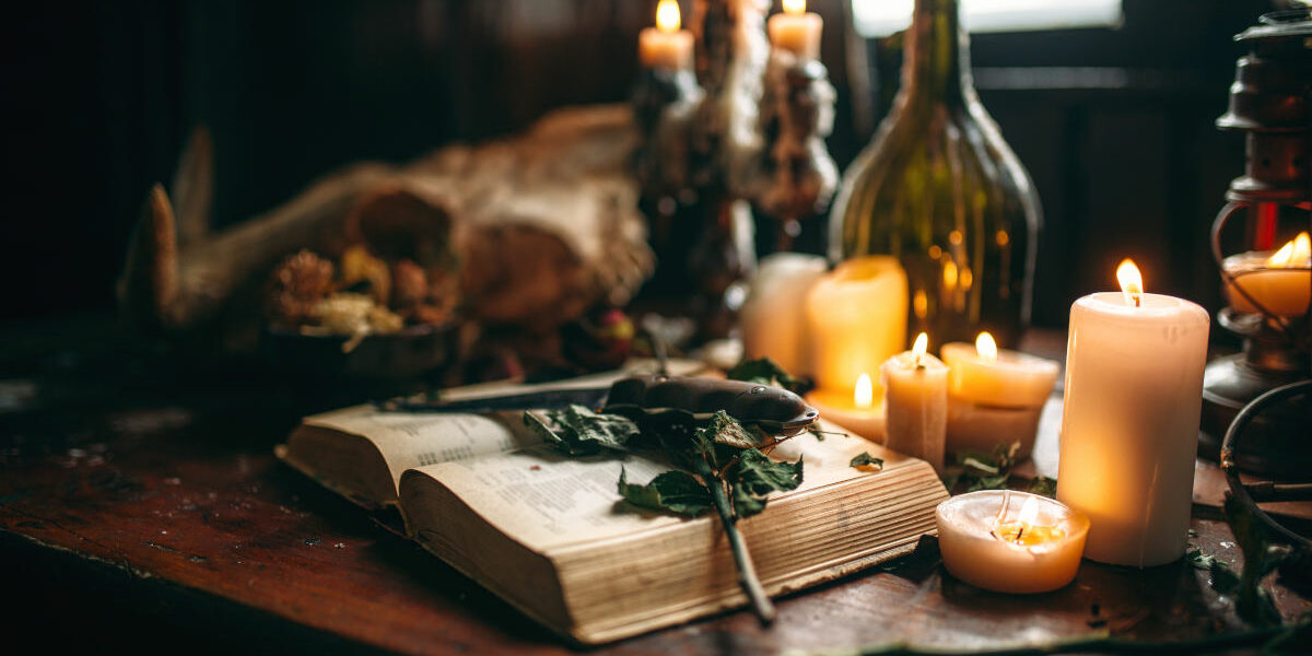 Witchcraft, dark magic, candles with ritual book