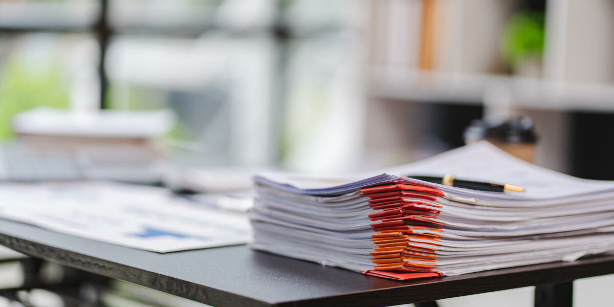 Document. A pile of documents with paper clip folders placed on