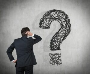 Thinking,Businessman,And,A,Question,Mark.